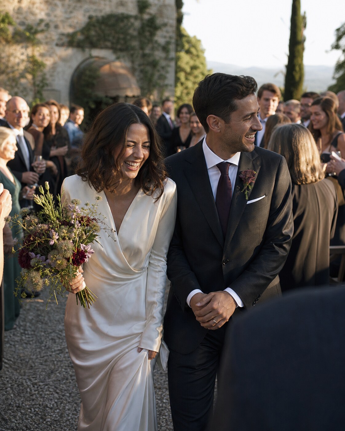 Newlyweds laugh together as they leave their ceremony