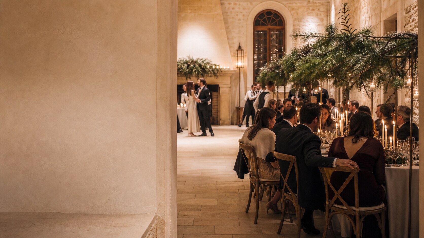 Guests share candlelit conversation around a long reception table